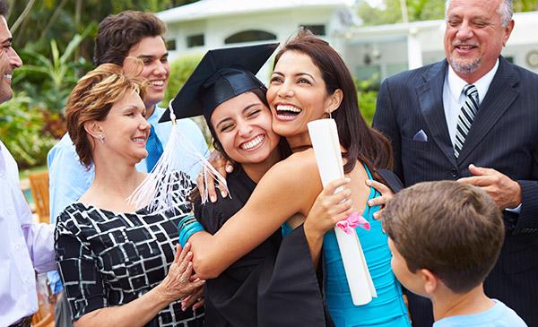 Hispanic Student And Family Celebrating Graduation